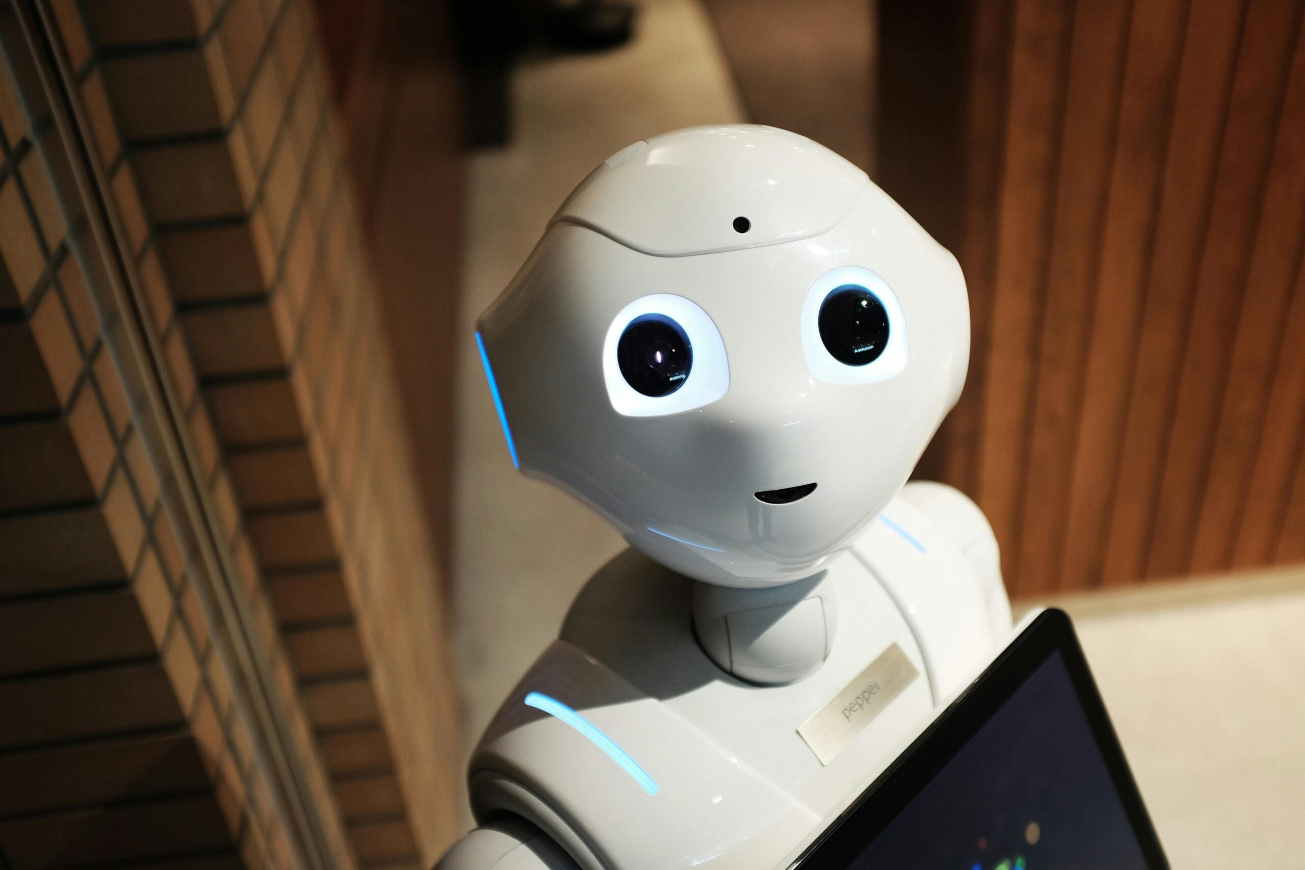 A cute, anthropomorphic robot face looking up at the camera